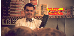 a smiling butcher holds a knife in a butchershop.